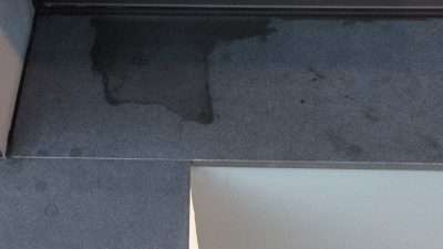 Granite Fireplace Oil Wax Stain Removal | Close up of the stain on the granite.